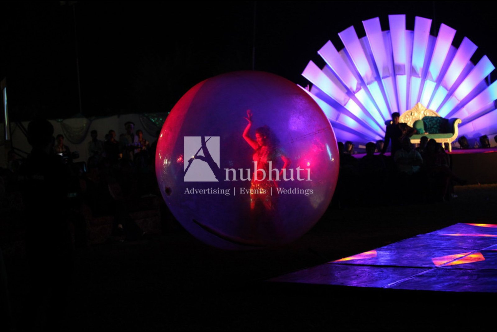 ITT event entrance with red and green carpet and pink lighting on white structure with ITT branding